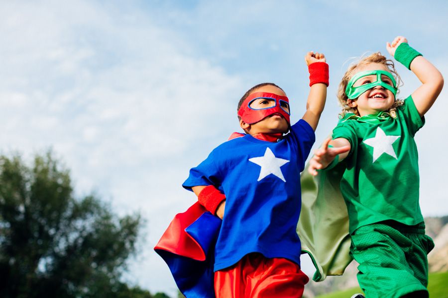 Children playing dressed as superheroes